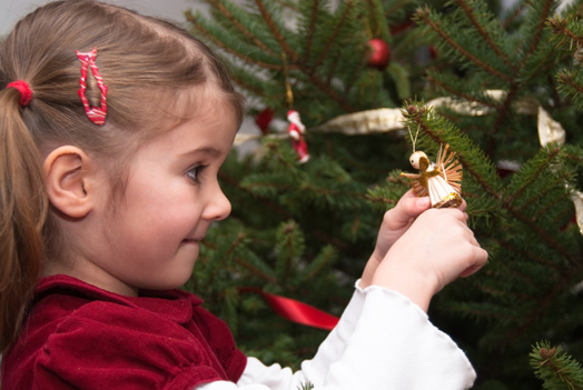 young_girl_decorating_a_christams_tree
